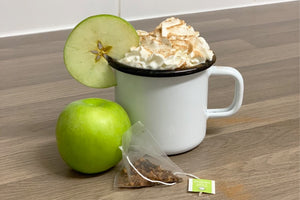 a mug of tasty cider with apple, cinnamon and whipped cream!