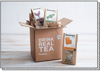 a variety of packs of tea bursting out of a delivery box