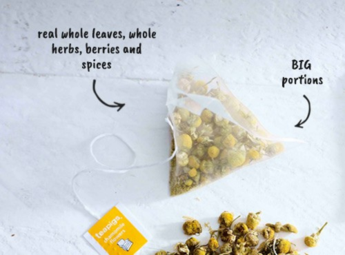 a teapigs teabag with an arrow pointing to the teabag that says 'real whole leaves, whole herbs, berries and spices' and 'BIG portions'